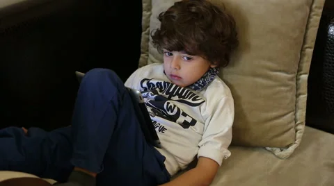 A boy on sofa with tablet Stock Footage 44393605