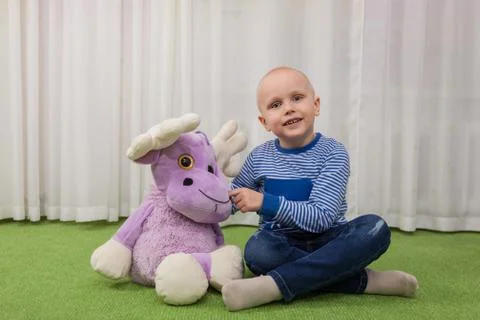 Boy with a soft toy Foto stock