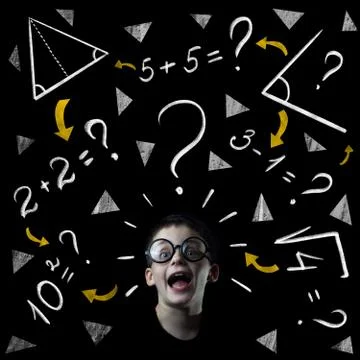 Boy solve mathematics examples at the blackboard Photos