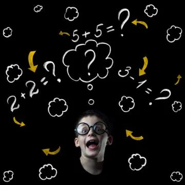 Boy solve mathematics examples at the blackboard 写真素材