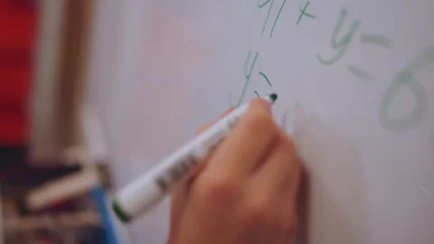 A boy solves an equation on the blackboard Stock Footage 262416942