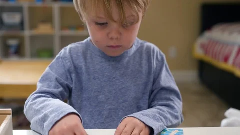 A Boy Solving A Jigsaw Puzzle Stock-Footage 129498712