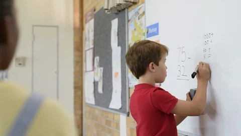 Boy solving math problem Stock Footage 96205310