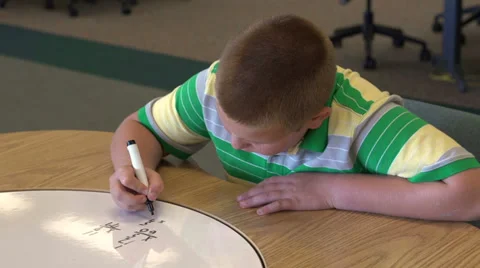 Boy solving math problems pan shot Stock Footage 26584682