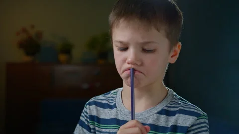 Boy Solving Problem, Smiling and Writing in Notebook, Close-Up Stock Footage 302877432