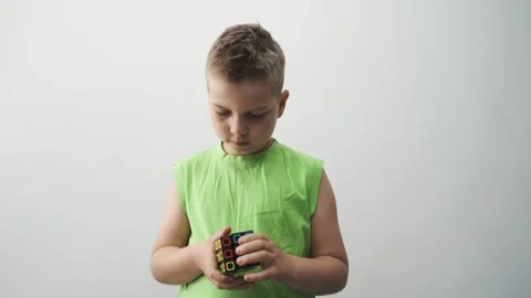 Boy Solving the Rubiks Cube. Young Boy C... | Stock Video | Pond5