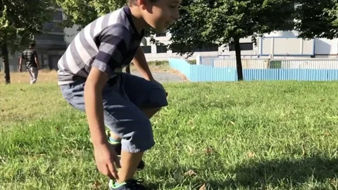 Boy somersault on grass in slow motion Stock Footage 138361807