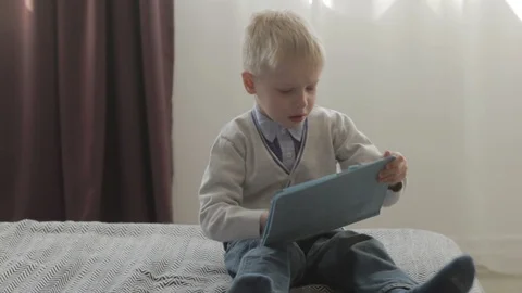 Boy something can not do on the tablet pc Stock Footage 94854536