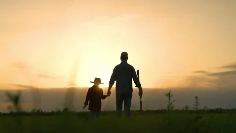 Boy son child father tree shovel plant farmer gardener field garden silhouette Stock Footage 282891373