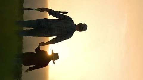 Boy son child father tree shovel plant farmer gardener field garden silhouette Stock Footage 300534359