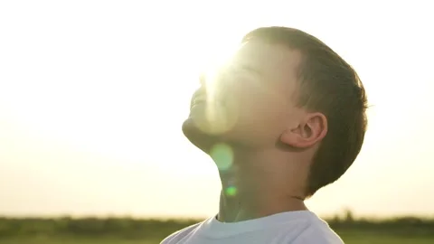 Boy son child looking sky happy face smile childhood dream prayer sun ask make Stock Footage 277304425