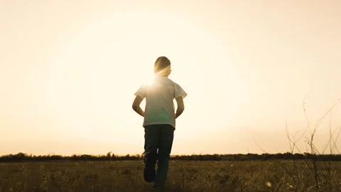 Boy son child running grass son sun sunset field park playground joyful happy Stock Footage 280365772