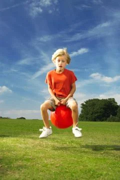 Boy on space hopper 写真素材