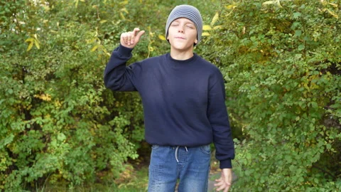 Boy speaks in front of video camera for his blog channel in autumn outdoors Stock Footage 168167797