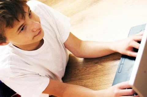 Boy spending time with notebook and modern technology Stock-Fotos