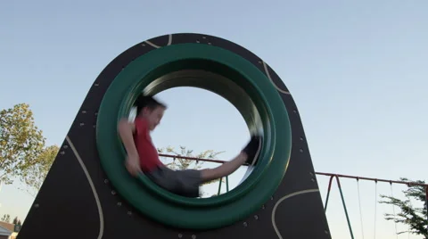 Boy Spinning on Playground Stock Footage 68068560