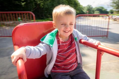 Boy spinning round on a carousel Stock Photos