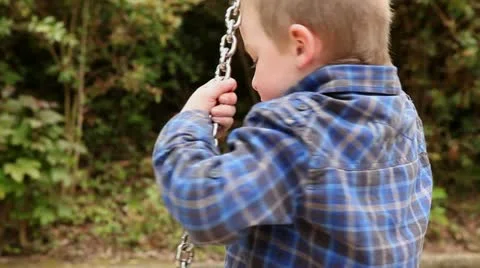 Boy spinning on swing Stock Footage 11024045