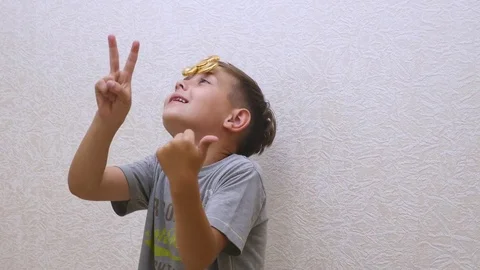 The boy spins the spinner at the head Stock Footage
