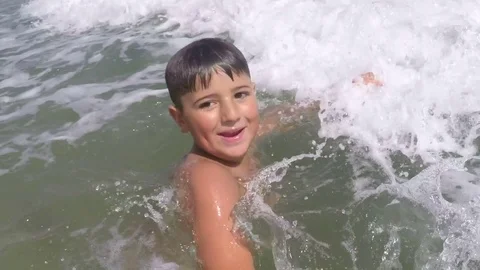 The boy splashes in the sea foam 스톡 동영상 81159457