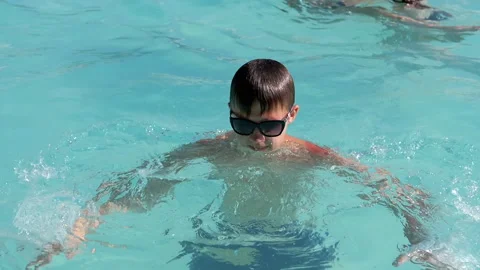Boy Splashing in the Pool Stock Footage 293180701