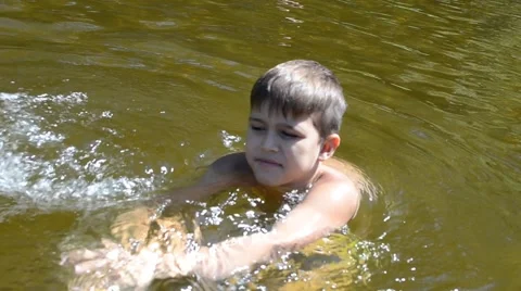 Boy splashing in the river Stock Footage 56828559
