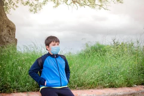 Boy with sportswear and backpack with field in the background taking a walk, Stock Photos