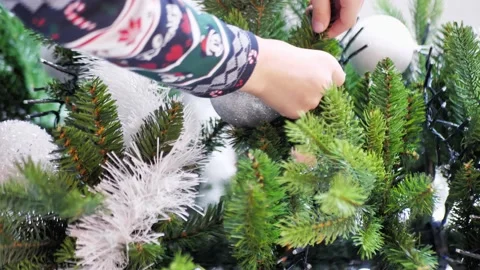 The boy spreads the branches of the Christmas tree Video stock 207084517