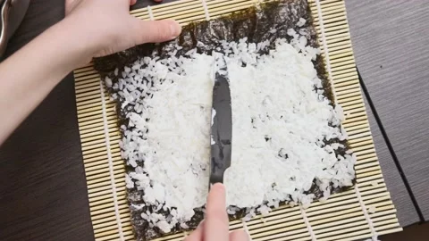 A boy spreads cheese on rice Stock Footage 232810714