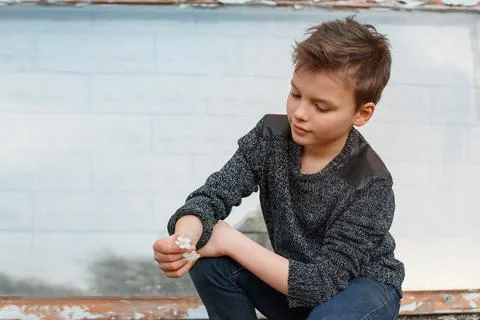 Boy squatting and squinting Stock Photos