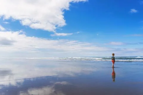 Boy standing on beach Stock Photos
