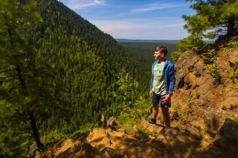 Boy standing at the forest hill Stock Photos