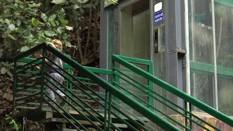 Boy standing in front of a crazy elevator located in jungles alon waterfall 動画素材 81278087
