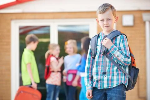 Boy Standing Outside School With Rucksack Stock Photos