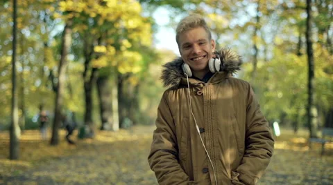 Boy standing in the park and smiling to the camera 스톡 동영상 57799285