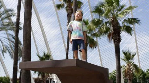 Boy Standing on Platform in Tropical Conservatory with Palm Trees Stock Photos