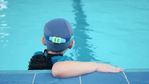 Boy standing in the pool and look at camera Stock Footage 150690763
