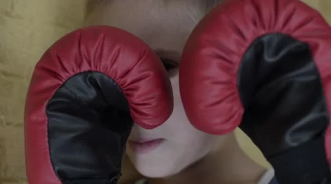 Boy standing in red boxing gloves Stock Footage 55838406