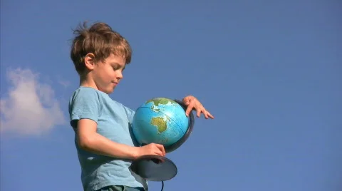 Boy standing rotates terrestrial globe 스톡 동영상 667132