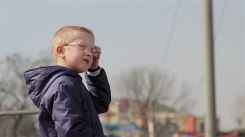 Boy standing on the side of the highway waiting for school bus. Stock Footage 66309339