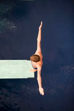 Boy standing on springboard Foto stock