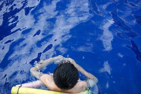 Boy standing in the swimming pool Stock Photos