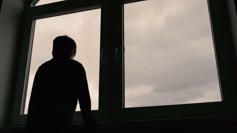 Boy standing at window and look at the sky Stock-Footage 74609737