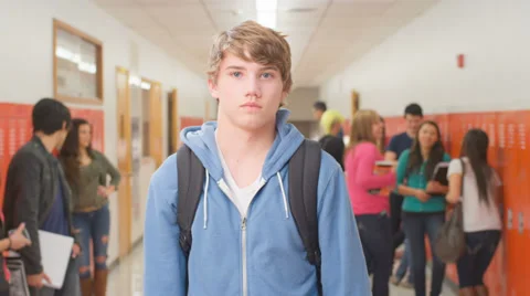 Boy stands in front of the camera and a girl comes up from behind and kisses him Video stock 33891235