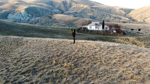 The boy stands in front of the sunset with his hand raised up Stock Footage 105026809