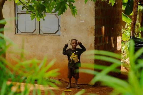 Boy stands on the threshold of a house Stock Photos