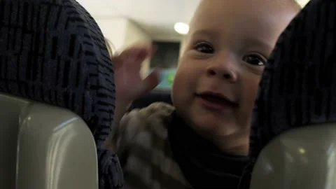 The boy stands at the train window and looks out the window at the running Stock Footage 221523111