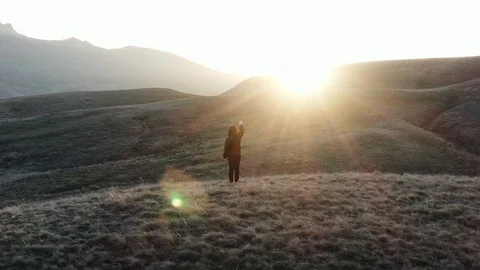 The boy starring hand toward sunlight Stands on the top of the hill Glare and Stock Footage 103311349