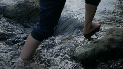 Boy stepping river stones Stock Footage 210101655
