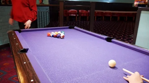 Boy strikes pool balls with cue Billards Stock Footage